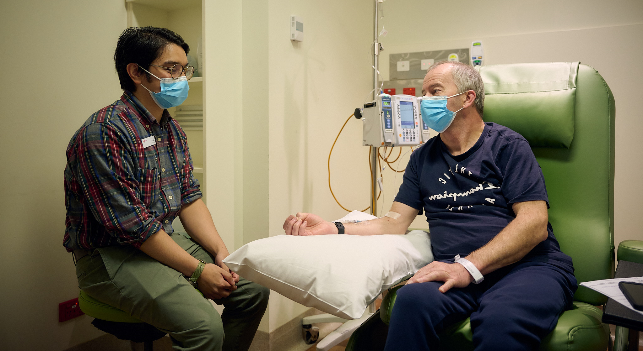 Patient receiving treatment in Day Oncology talking to a doctor