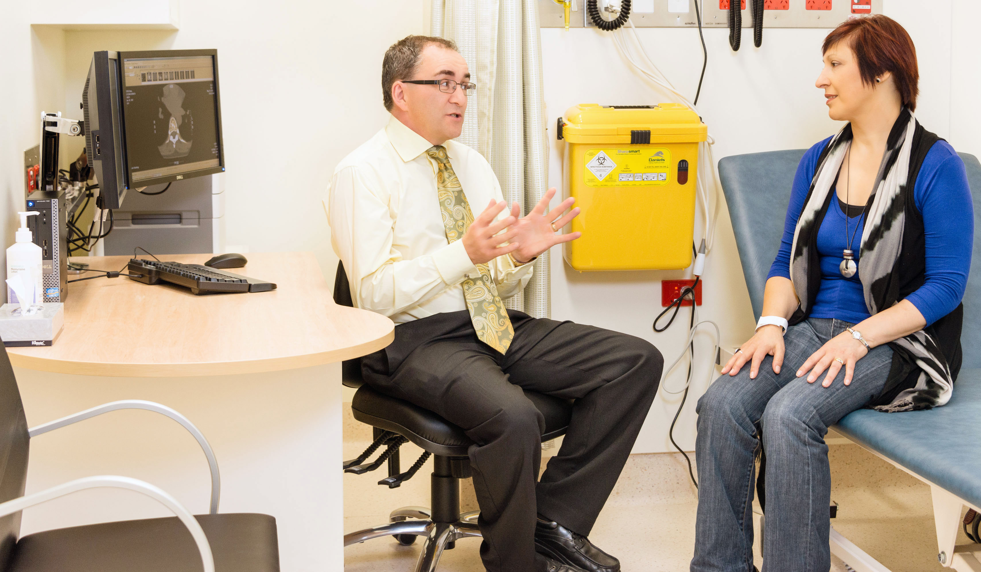 Doctor speaks to a patient in the Family Cancer Clinic
